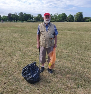 Cllr John Mylod litter picking in St. Andrew's Park